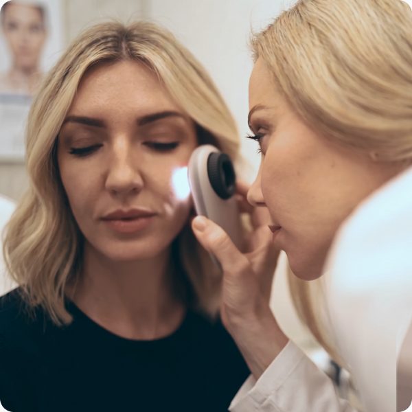 Dermatologist examining a patient’s skin before a cyst removal